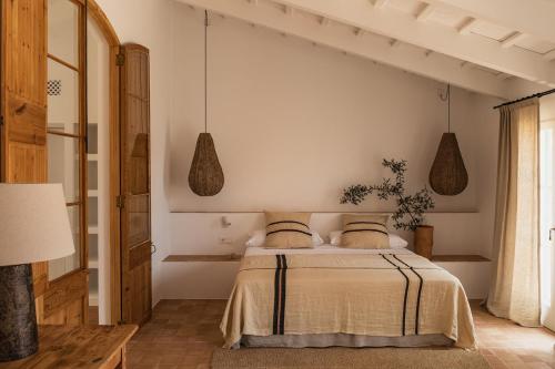 a bedroom with a bed with two pillows at Hotel Rural Sant Ignasi in Ciutadella