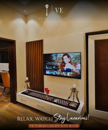 a flat screen tv on a wall in a living room at Victorian Elegance Luxury Stays in Amritsar