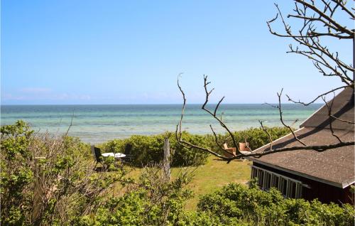 a house on the beach with the ocean in the background at Beautiful Home In Samsø With Kitchen in Ballen