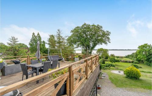 a wooden deck with a table and chairs on it at Two-Bedroom Apartment Stege 0 03 in Stege