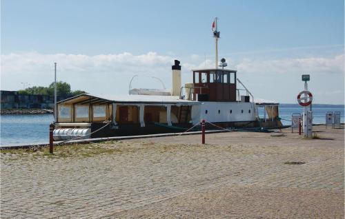 a boat is docked on the shore of the water at Two-Bedroom Apartment Stege 0 03 in Stege
