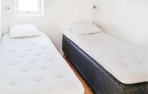 two twin beds in a room with a window at Beautiful Home In Dalslånged With Wifi in Dals Långed