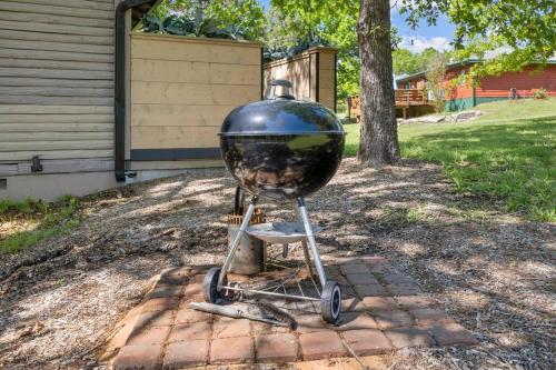a grill on a stand in front of a house at Serenity - 60 Ridge Lane in Branson