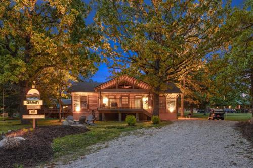 a house with a sign in front of it at Serenity - 60 Ridge Lane in Branson