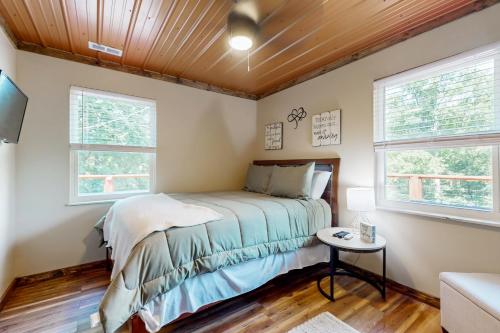 a bedroom with a bed and two windows at Cattie Shack in Alder