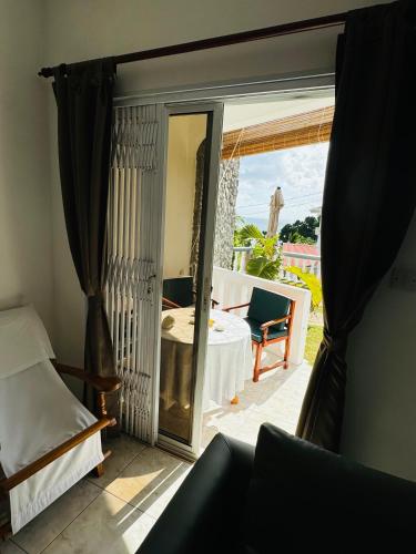 a room with a sliding glass door to a patio at D BES Residence Self Catering in Beau Vallon
