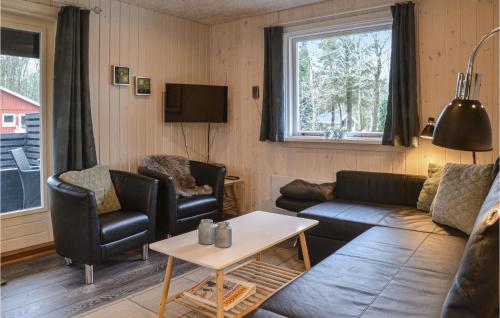 a living room with a couch and chairs and a table at Two-Bedroom Holiday Home In Ansager in Ansager