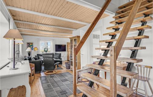 a wooden spiral staircase in a living room at Holiday Home Haveskovvej Humble Xii in Humble