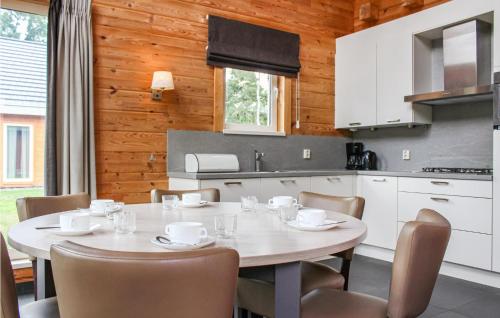 a kitchen and dining room with a table and chairs at Lovely Home In Heel With House Sea View in Heel