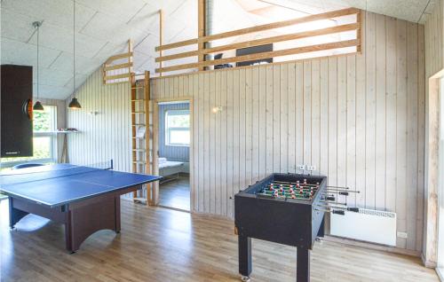 a ping pong table in a living room with a ping pong table at Holiday Home Flovt Havevej Haderslev Iii in Råde