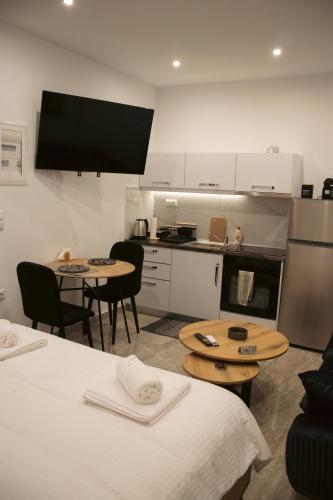 a kitchen with two tables and two chairs and a kitchen with a kitchen at Emily Apartments 2 in Chrysoupolis