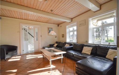 a living room with a couch and a table at Holiday Home Østerende in Ballum