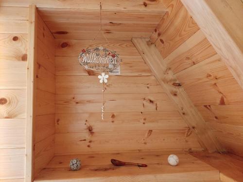 a wooden sauna with a chandelier hanging from the ceiling at Eco resort Komarnica in Šavnik