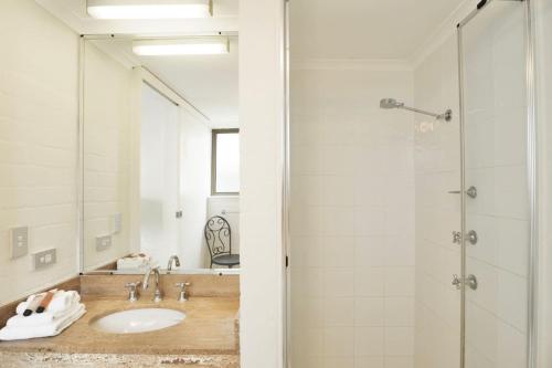 a bathroom with a sink and a shower at Beach Lovers Dream 2BR in Noosa Heads