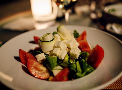 a plate of food with vegetables on a table at InterContinental Bora Bora Le Moana Resort by IHG in Bora Bora
