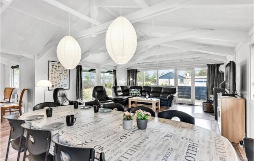 a living room with a large table and chairs at Five-Bedroom Holiday Home In Blokhus in Blokhus