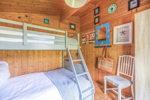 a bedroom with bunk beds in a cabin at Scandinavian Style Lodge in Rock in Wadebridge