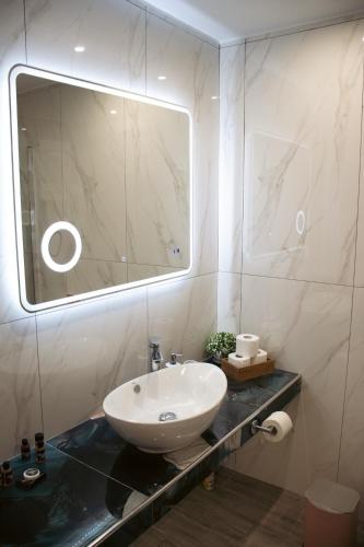 a bathroom with a sink and a mirror at Emily Apartments 3 in Chrysoupolis