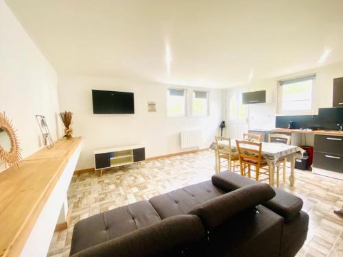 a living room with a couch and a table at Chez Sylvie in Pont-Rémy