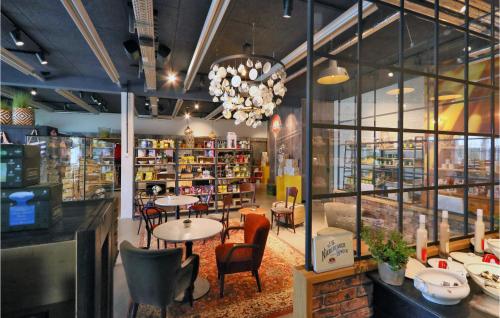 a restaurant with tables and chairs in a store at Priwallpromenade 27, Whg 6 in Priwall