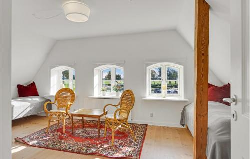 a room with a table and chairs and a bed at 3 Bedroom Nice Home In Kværndrup in Kværndrup