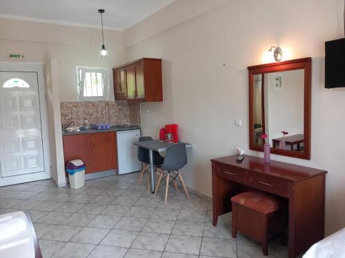 a kitchen with a desk and a sink and a table at NIKOS DIMAS STUDIOS in Parga