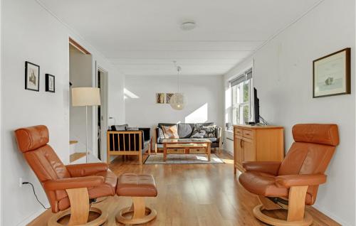 a living room with two chairs and a couch at Holiday Home Højskolevej Kruså Iii in Rønsheved