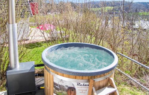 a hot tub with water in it in a field at Ferienhaus 44 In Kirchheim in Kemmerode