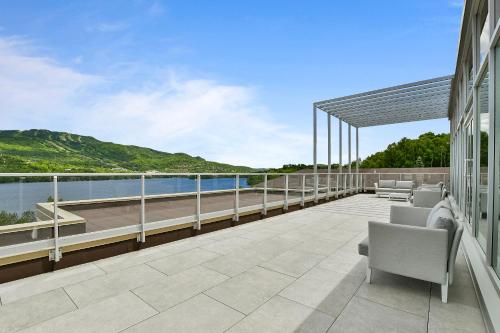 a balcony with chairs and a view of the water at Lago by Tremblant Platinum in Mont-Tremblant