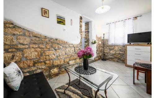 a living room with a table with a vase of flowers at 1 Bedroom Lovely Home In Barat in Barat