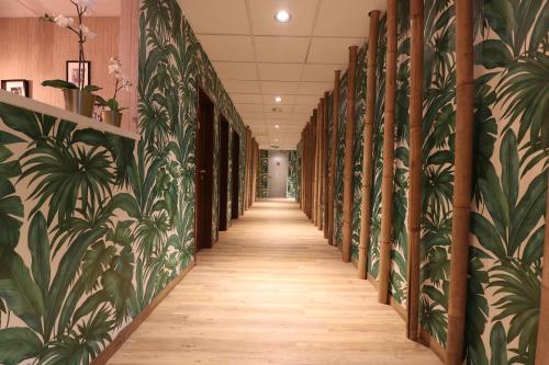 a hallway with a mural of plants on the walls at SP Duna in Budapest
