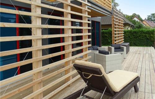 a chair sitting on a deck next to a building at Haus 9 in Wendorf