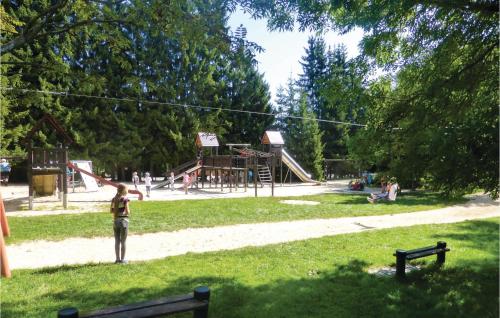 a person standing in a park with a playground at Cozy Apartment In Auerbach Ot Grünheide in Grünhaide