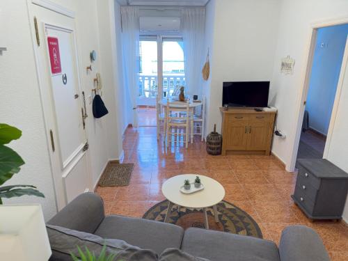 un salon avec un canapé et une table dans l'établissement Torrevieja Seaside Escape, à Torrevieja