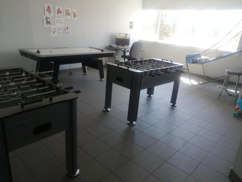 a room with two tables and a ping pong table at Parc du Mont-Citadelle in Saint-Honoré-de-Témiscouata