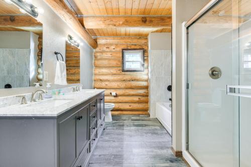 a bathroom with two sinks and a shower at Riverfront Montana Log Cabin with Mountain Views! in Melrose