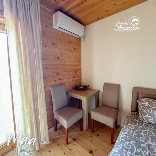 a bedroom with a table and two chairs and a bed at Apartmani Konoba Starčevo in Virpazar