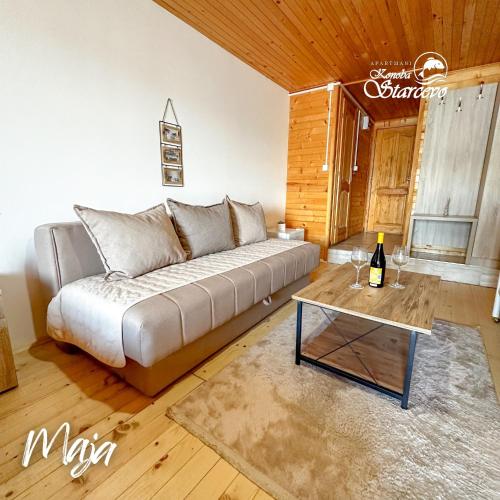 a living room with a couch and a table at Apartmani Konoba Starčevo in Virpazar