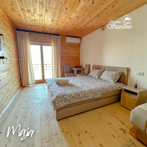 a bedroom with a bed with a wooden ceiling at Apartmani Konoba Starčevo in Virpazar