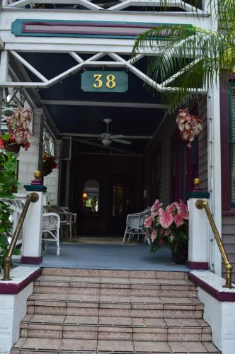 a front porch of a house with a clock on it at Old Powder House Inn in Saint Augustine