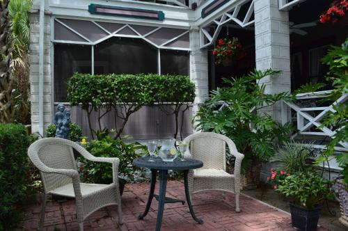 two chairs and a table on a patio at Old Powder House Inn in Saint Augustine