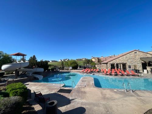 a large swimming pool with lounge chairs in a resort at Flying Horse Resort & Club in Colorado Springs
