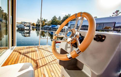 a steering wheel on a boat in a marina at Amazing Ship In Hennigsdorf in Hennigsdorf