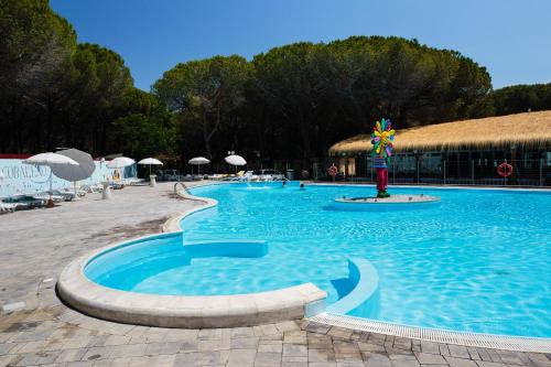 a swimming pool in a resort with afficientfficientfficient at Arcobaleno Village in Marina di Bibbona