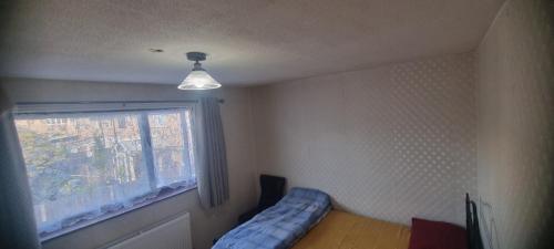 a bedroom with a bed and a window at Private and Quiet Room in Harlow near Stansted Airport in Harlow
