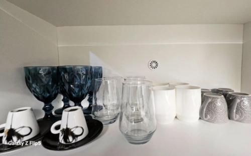 a group of glass vases sitting on a counter at Kontili house in Skiros