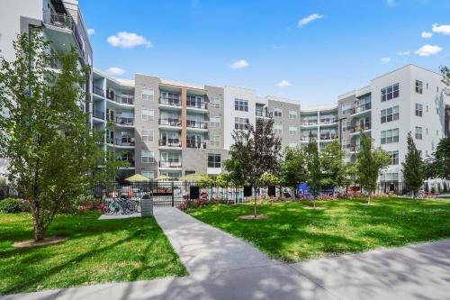 an apartment building with a park in front of it at Kasa on the River Boise in Boise