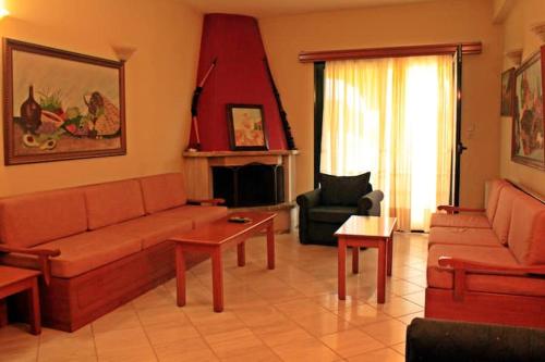 a living room with a couch and a chair at Guesthouse Bizani in Neo Mpizani