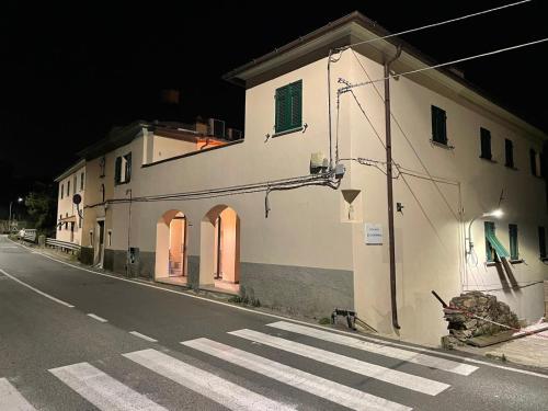 a building on the side of a street at night at Il Piccolo Convento- NUOVA GESTIONE 2025- in La Spezia