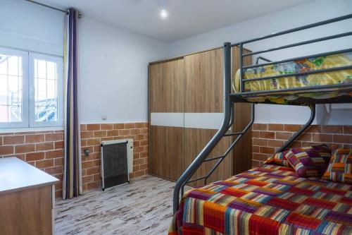 a bedroom with a bunk bed and a kitchen at Forest Farm in Amman